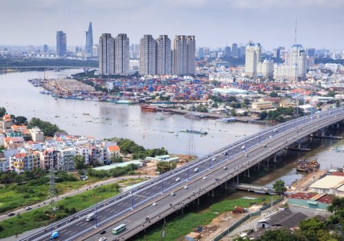 An aerial shot showcasing the skyline and river of Ho Chi Minh City, highlighting its urban landscape.