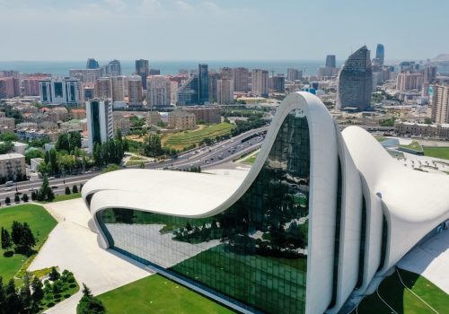 Aerial view of the Heydar Aliyev Centre in Baku, showcasing modern architecture and city landscape.